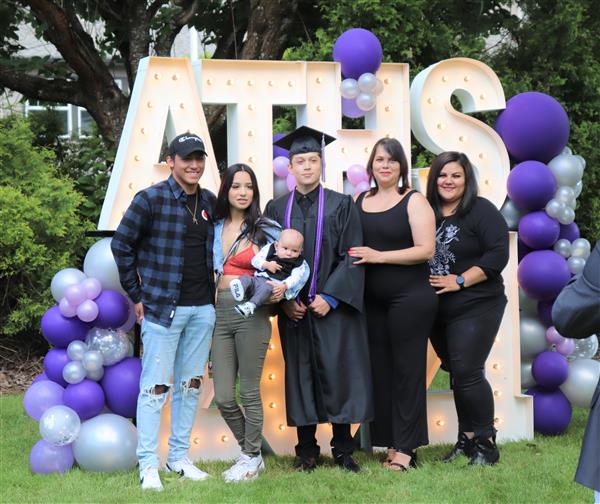 Arts and Technology graduate takes a picture with family after graduation on June 9.